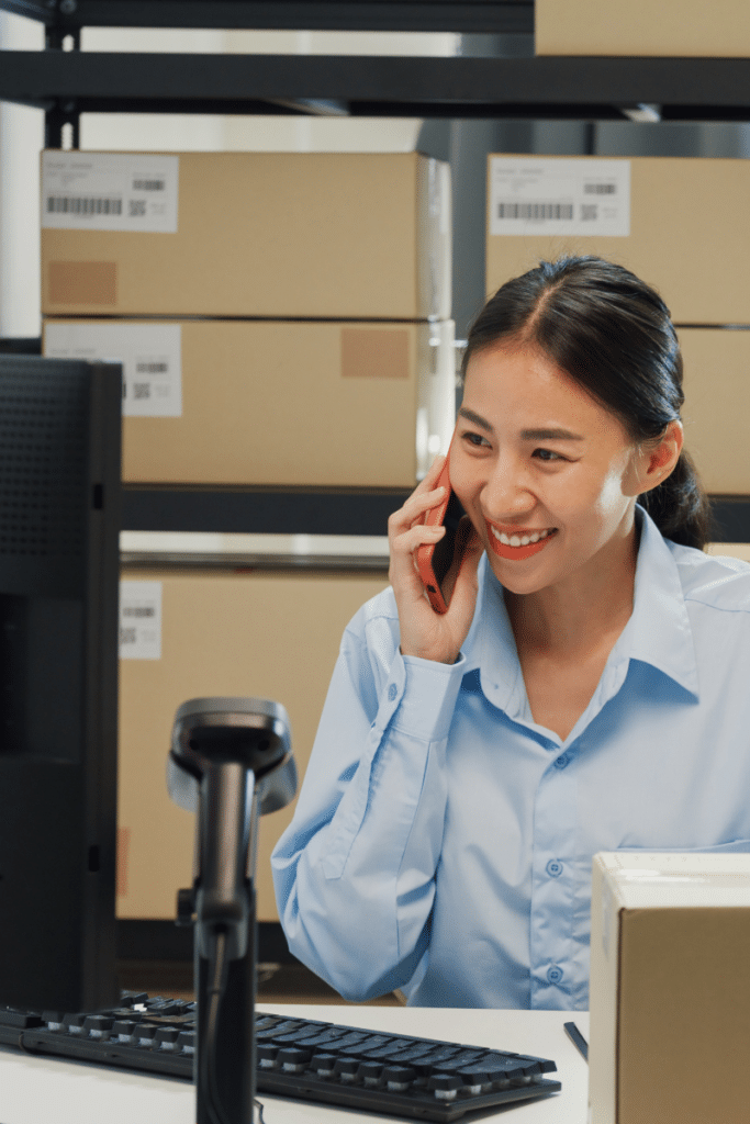 Worker in warehouse helping carrier develop strategy and shipping