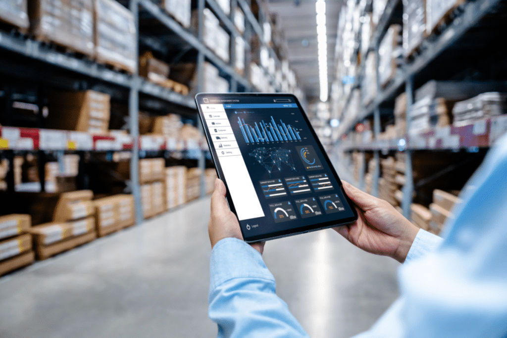 Person in Warehouse Doing 2026 Shipping and Logistics on Tablet