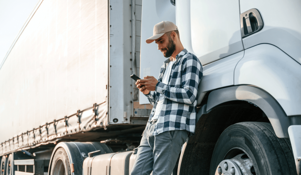 Truck Driver on Phone Amid Rising Carrier Rejections