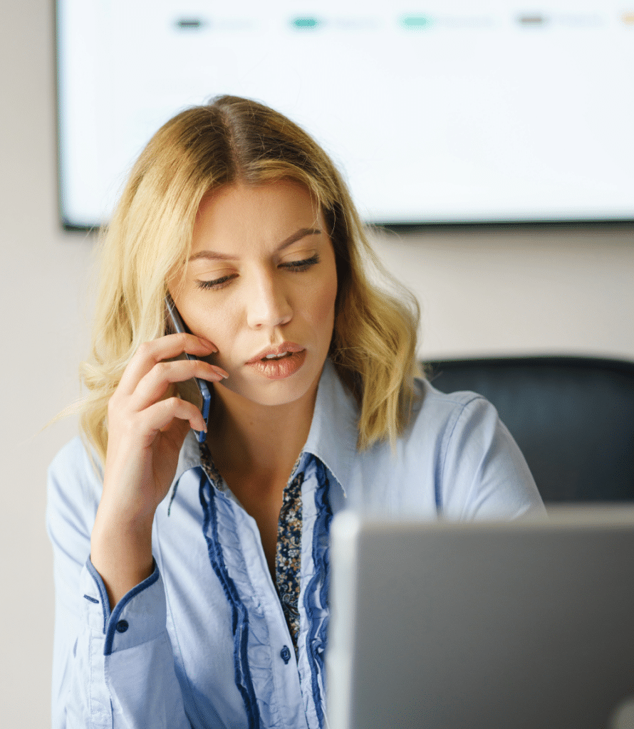 Woman on phone trying to reduce freight costs with carrier